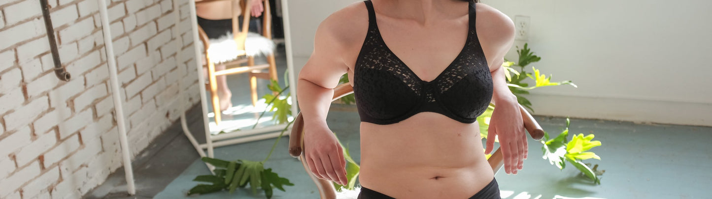 Image of woman sitting in a chair wearing a unlined and supportive bra from Chantelle.