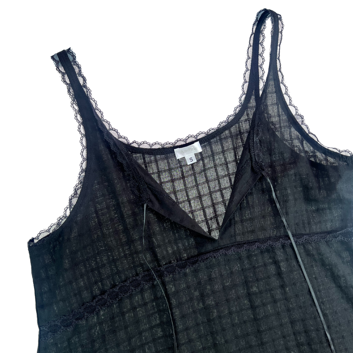 Black lace-trimmed dress on a white background