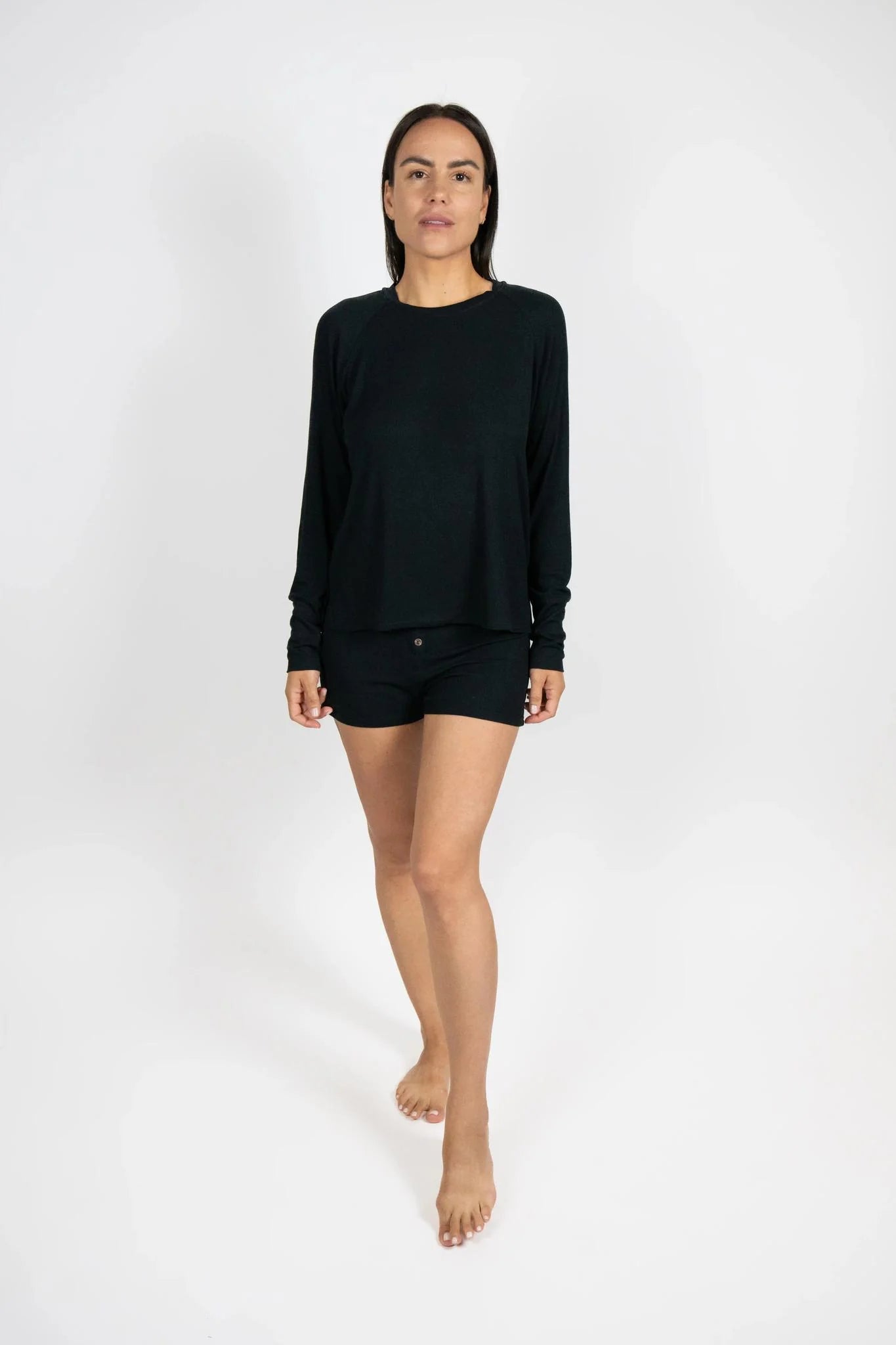 woman wearing black pajamas against a white background
