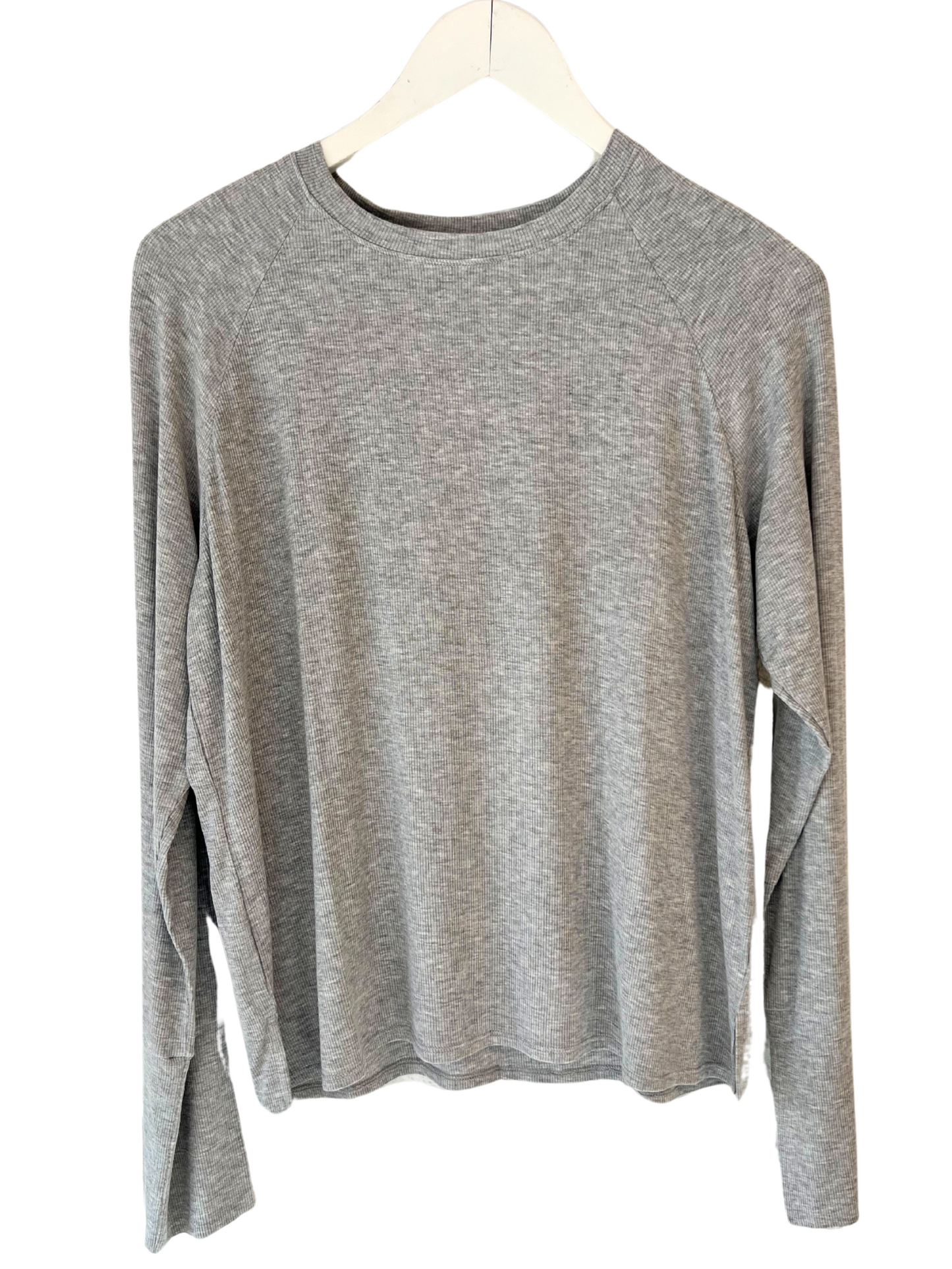A long-sleeve gray ribbed top hanging on a hanger, displaying the relaxed fit and shoulder detail.