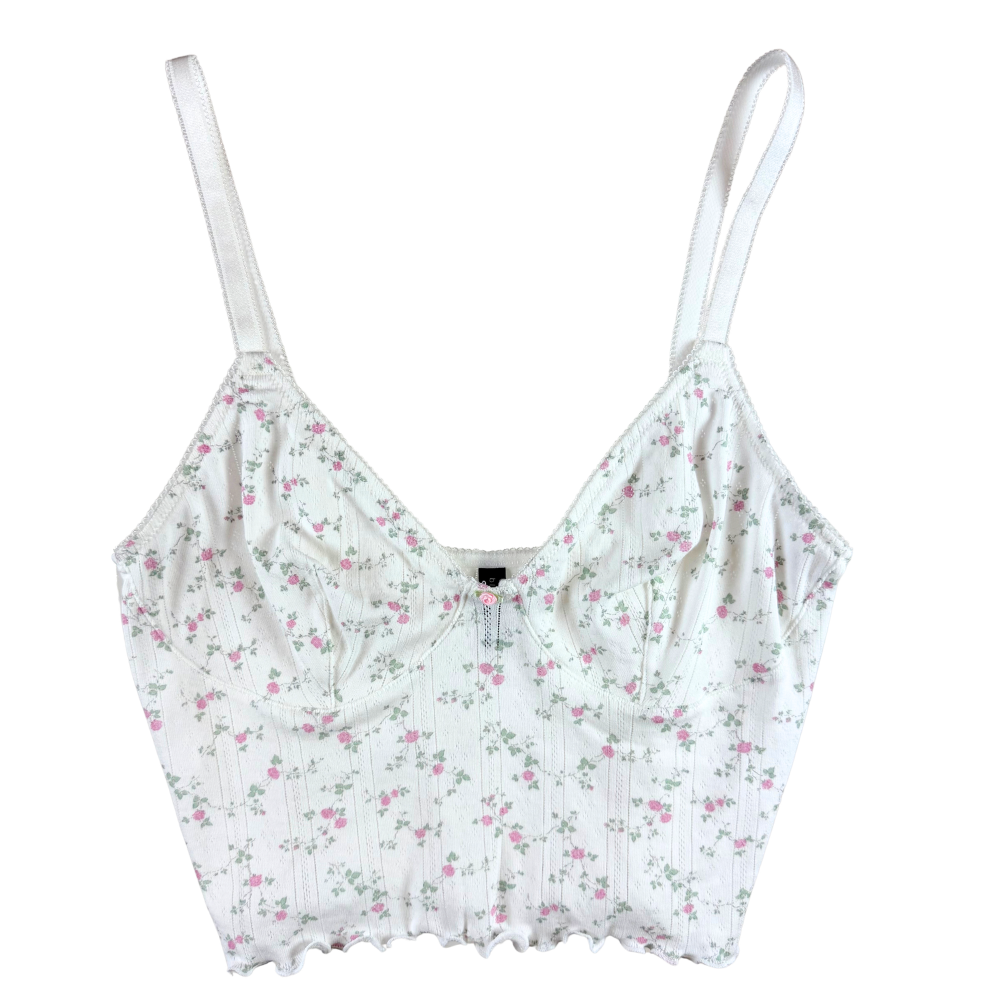 white pointelle crop cami with pink and green florals against a white background.