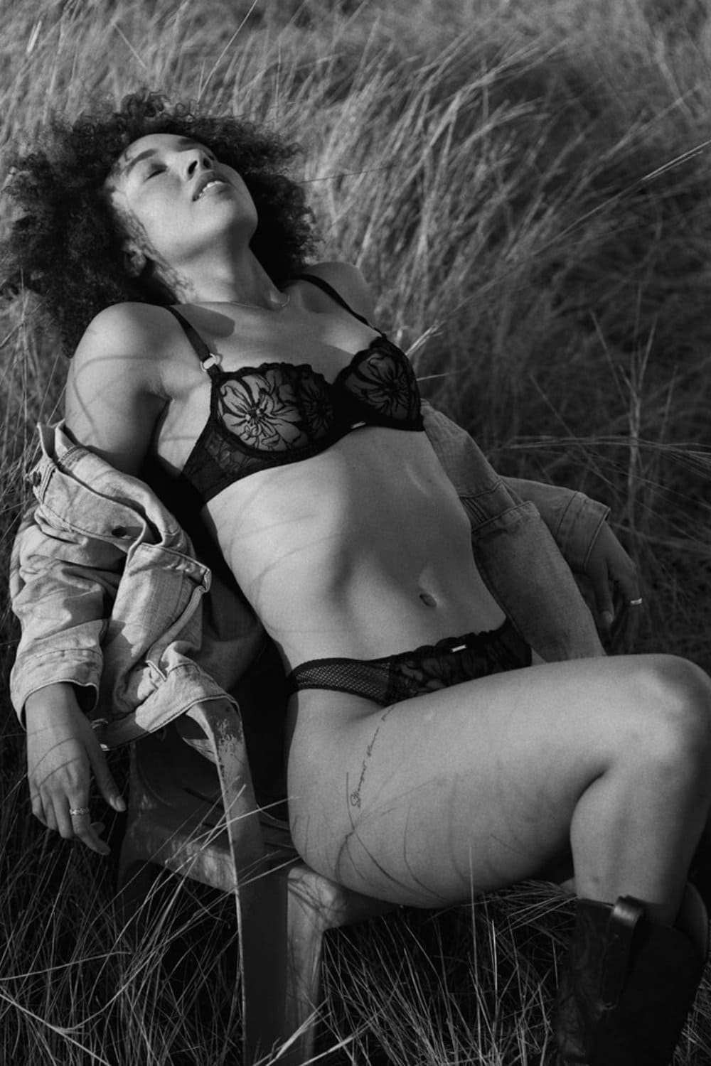 Chantelle Fleurs Demi Bra in black, front view on a model, model sitting, black and white shot.