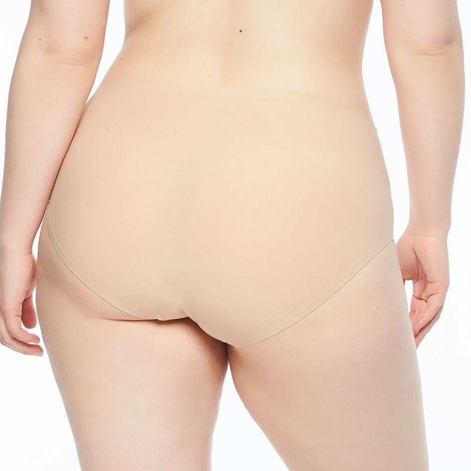 Person wearing beige underwear against a white background