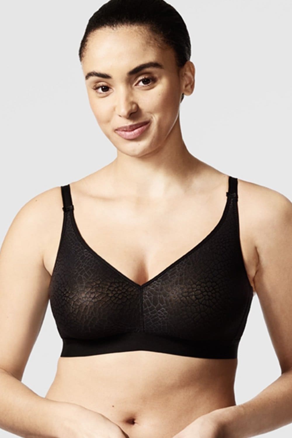 Chantelle C-Magnifique full bust wirefree bra in black, front view on a model, close-up, on white background.