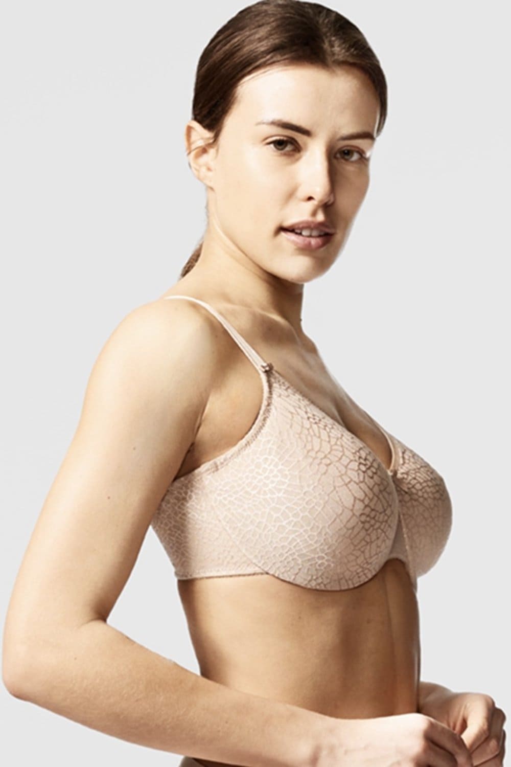 Chantelle C-Magnifique molded minimizer bra in ultra nude, front-side view on a model.