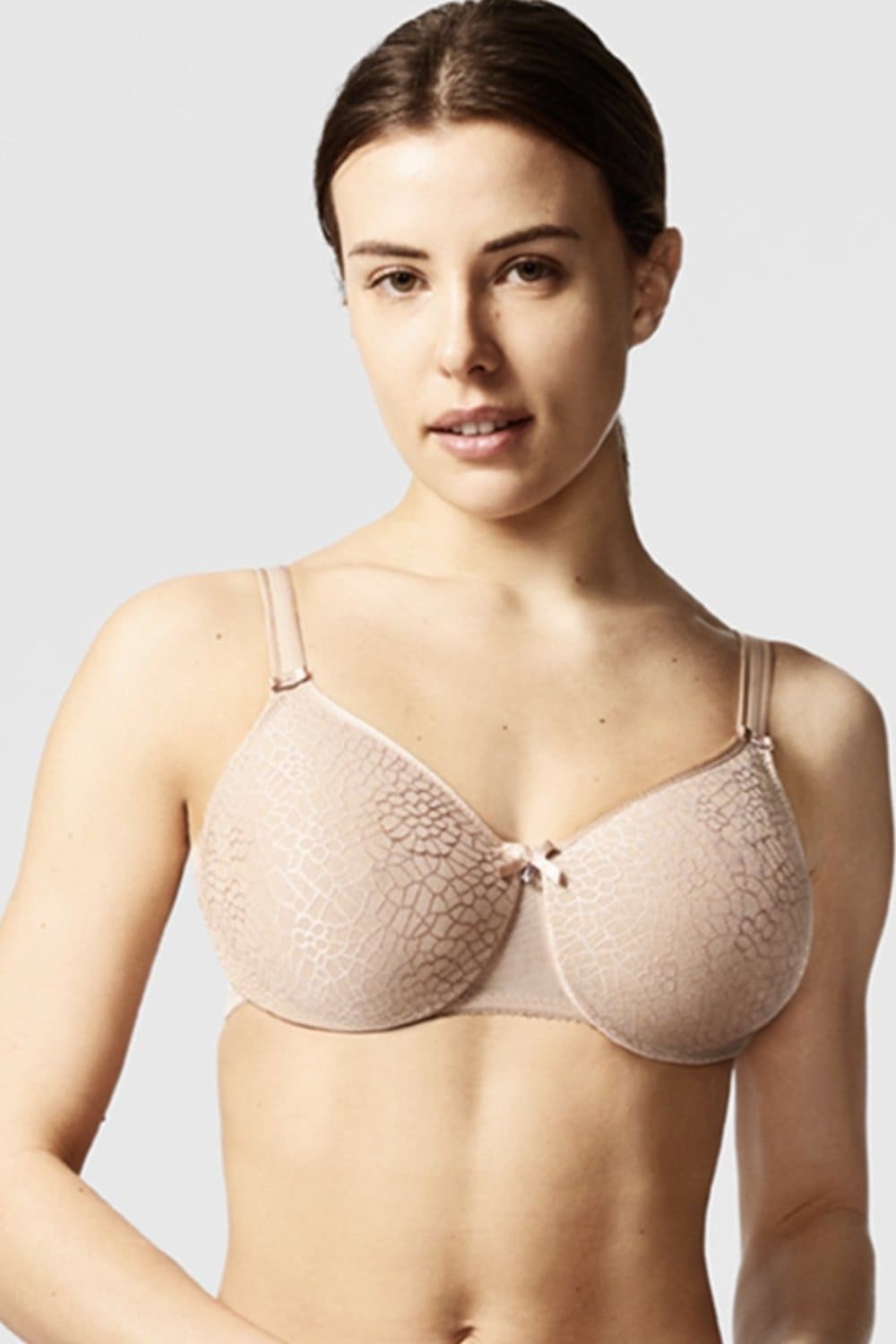 Chantelle C-Magnifique molded minimizer bra in ultra nude, front view on a model, distant.