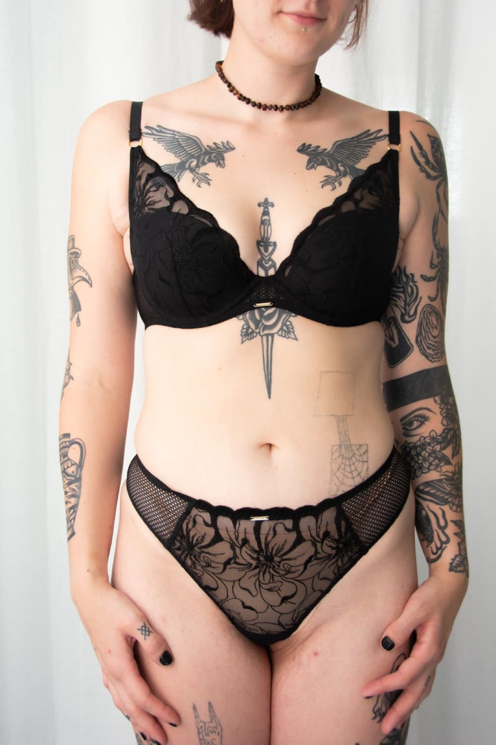 Chantelle Fleurs thong in black, front view on a model.