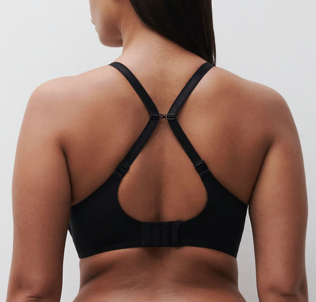 Black sports bra worn by a person on a plain background
