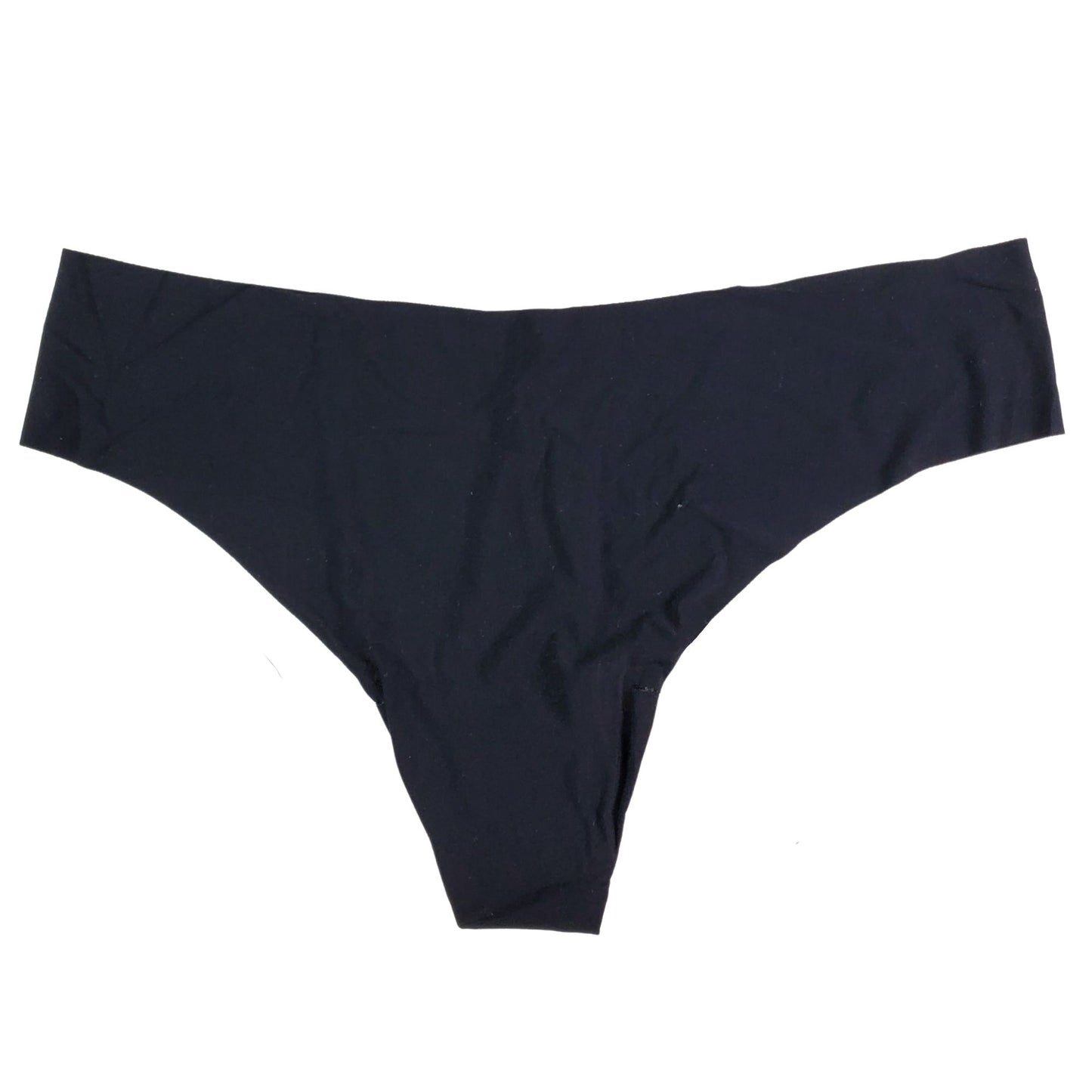 A beige Commando brand seamless thong underwear laid flat on a surface.