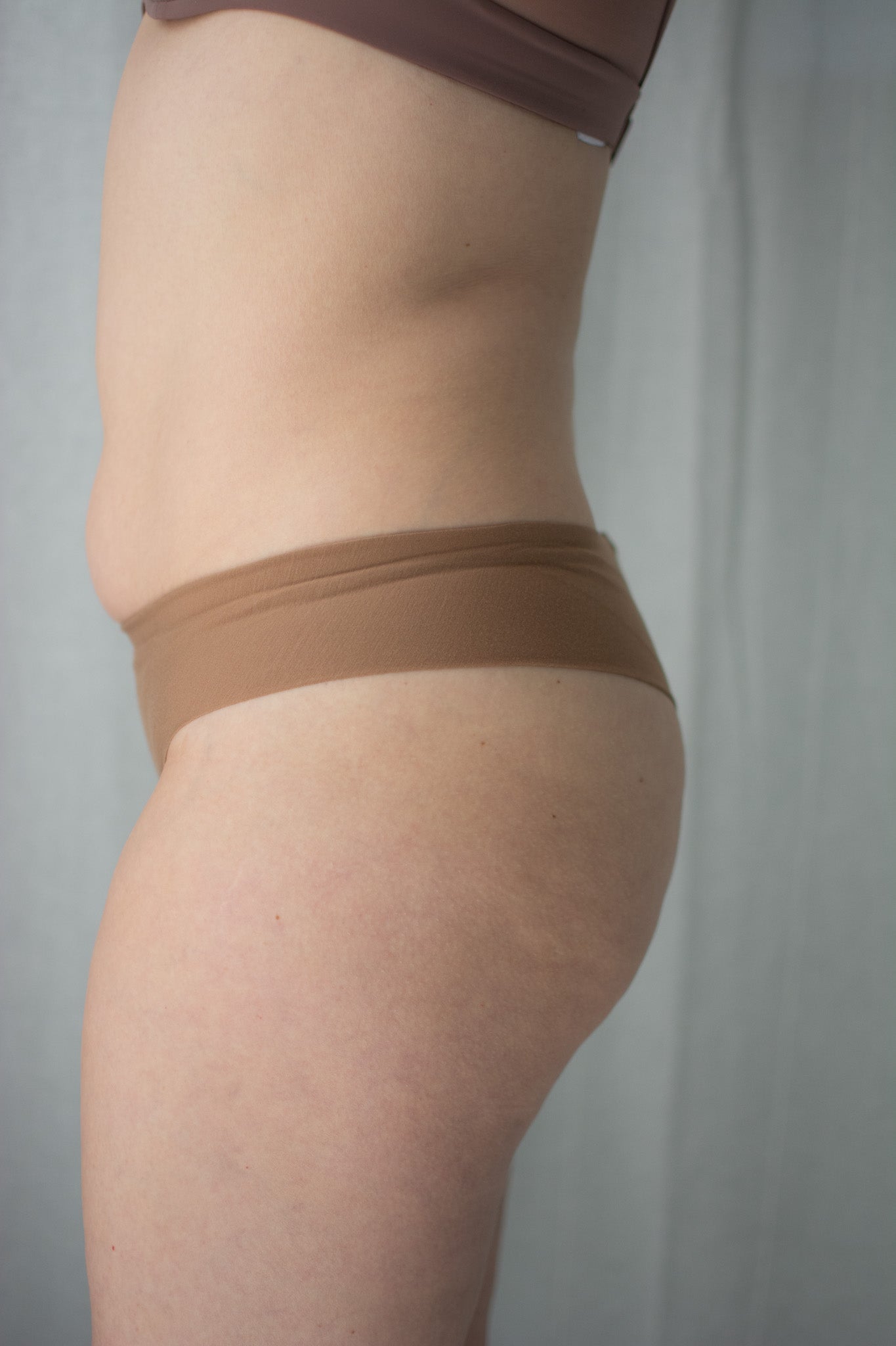 Brown underwear worn by a person on a plain background
