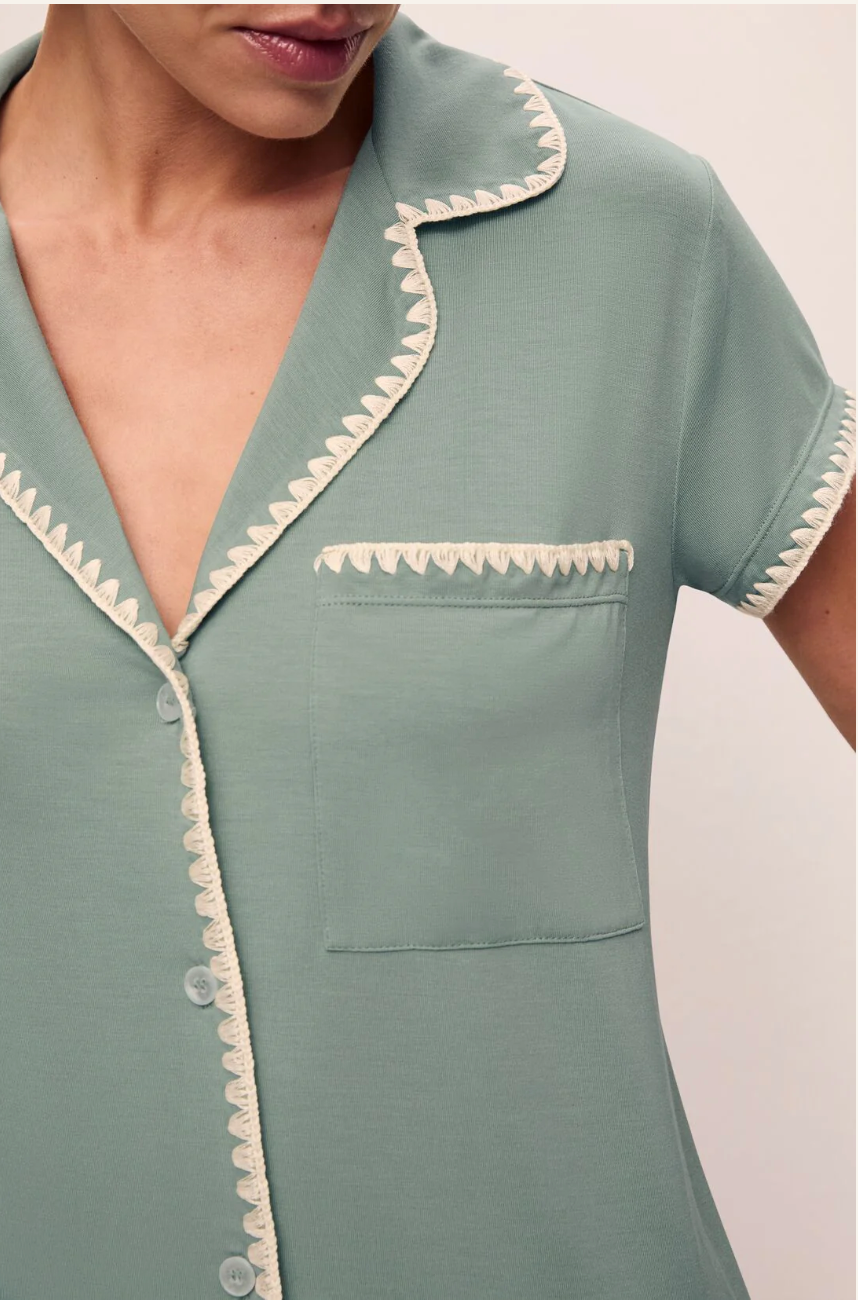 person wearing green pjs against a white background.