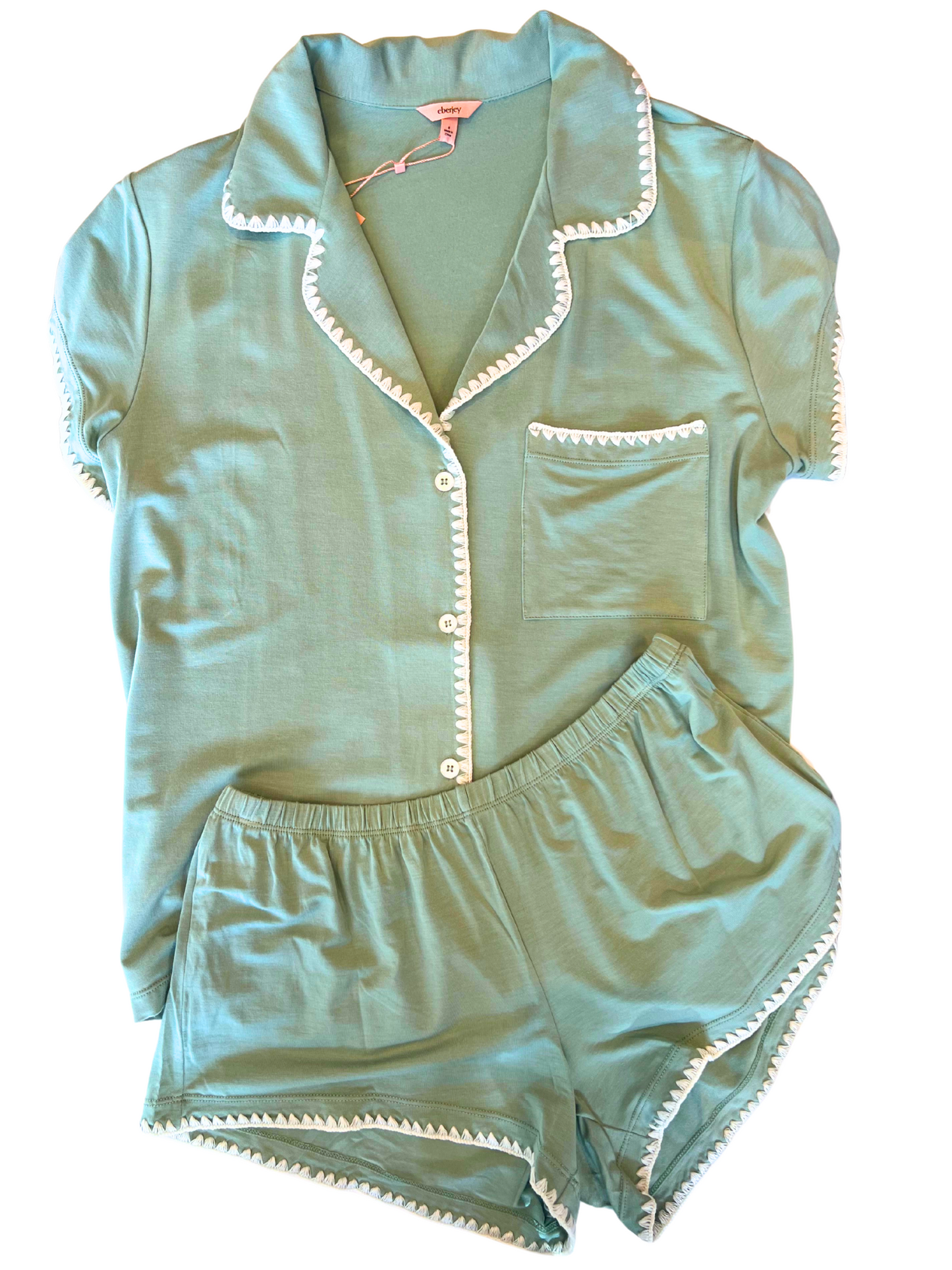 green pjs with a white stitch trim against a white background.