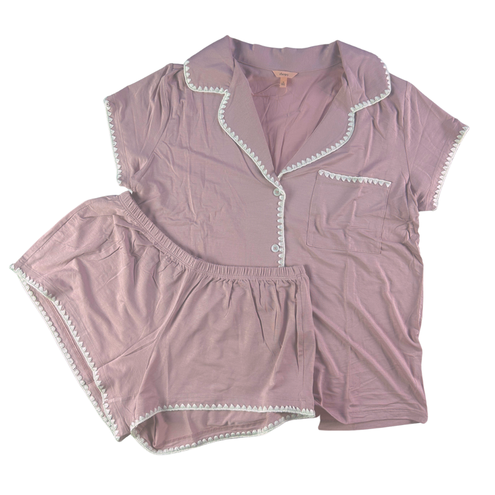 A two-piece women's pajama set in dusty mauve pink, featuring a short-sleeve button-front top with white pom-pom trim and matching shorts with elastic hems and white pom-pom trim, laid flat on a white background.