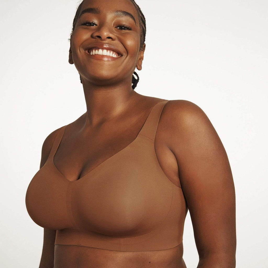 woman wearing brown bra white background