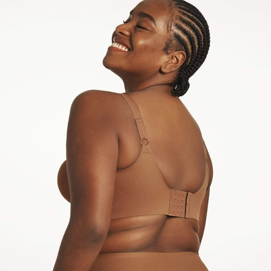 woman wearing brown bra white background