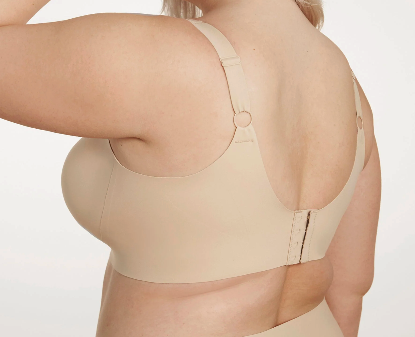 Beige shapewear garment worn by a person on a plain background
