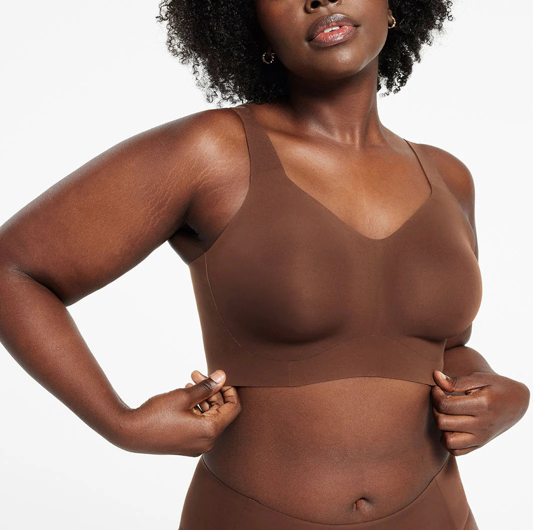 woman wearing brown bra white background
