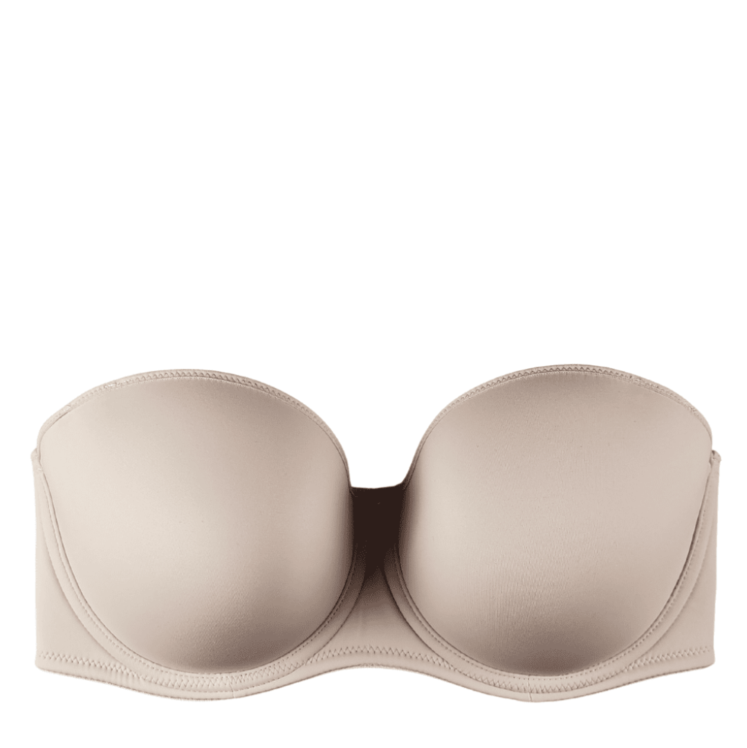 beige strapless bra against a white background