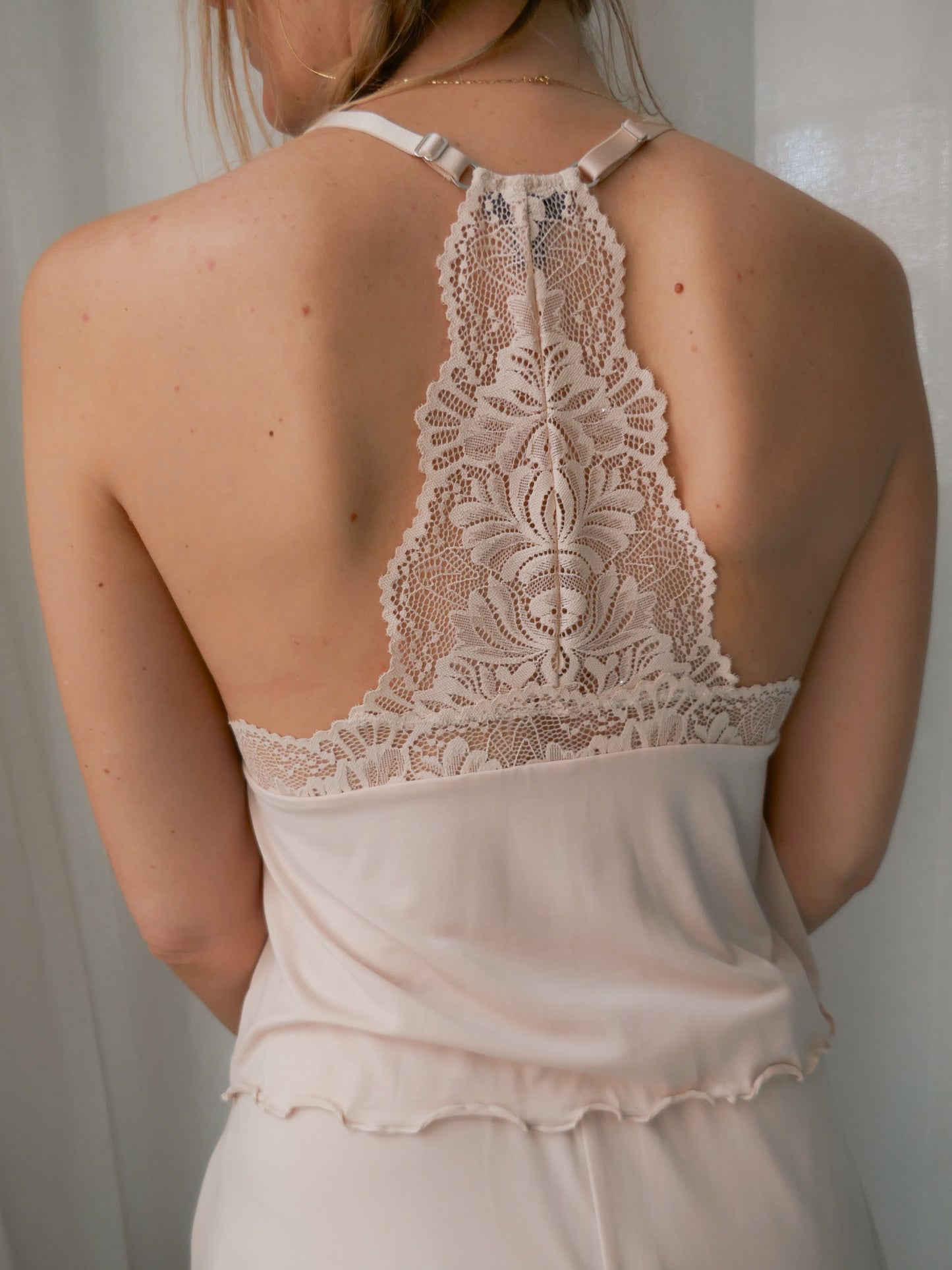 Lace-trimmed nightgown with open back on a neutral background