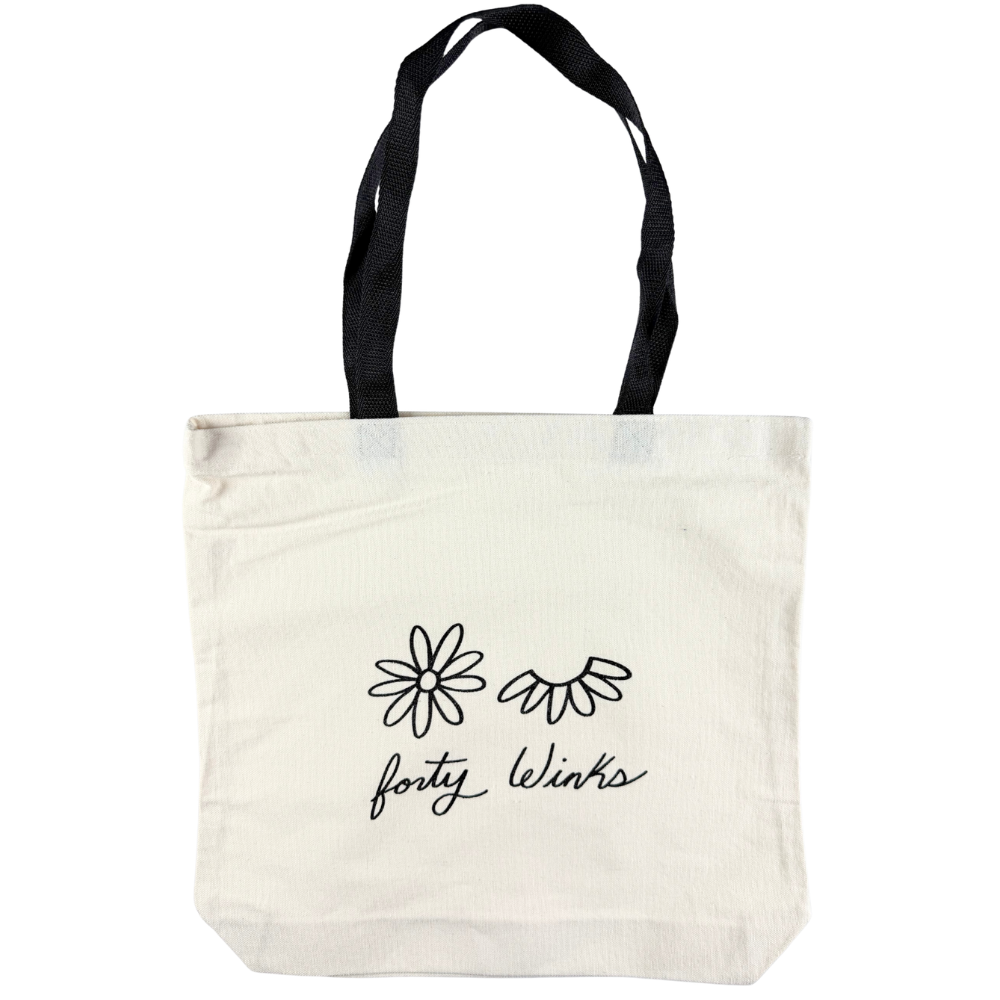 White tote bag with black handles and 'forty winks' text and flower graphics on a white background