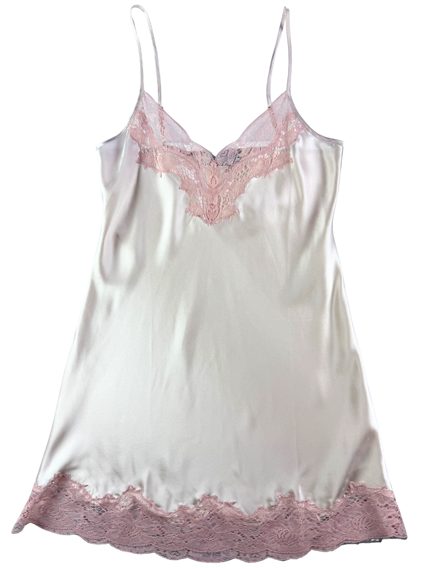 White satin slip with pink lace trim on a white background