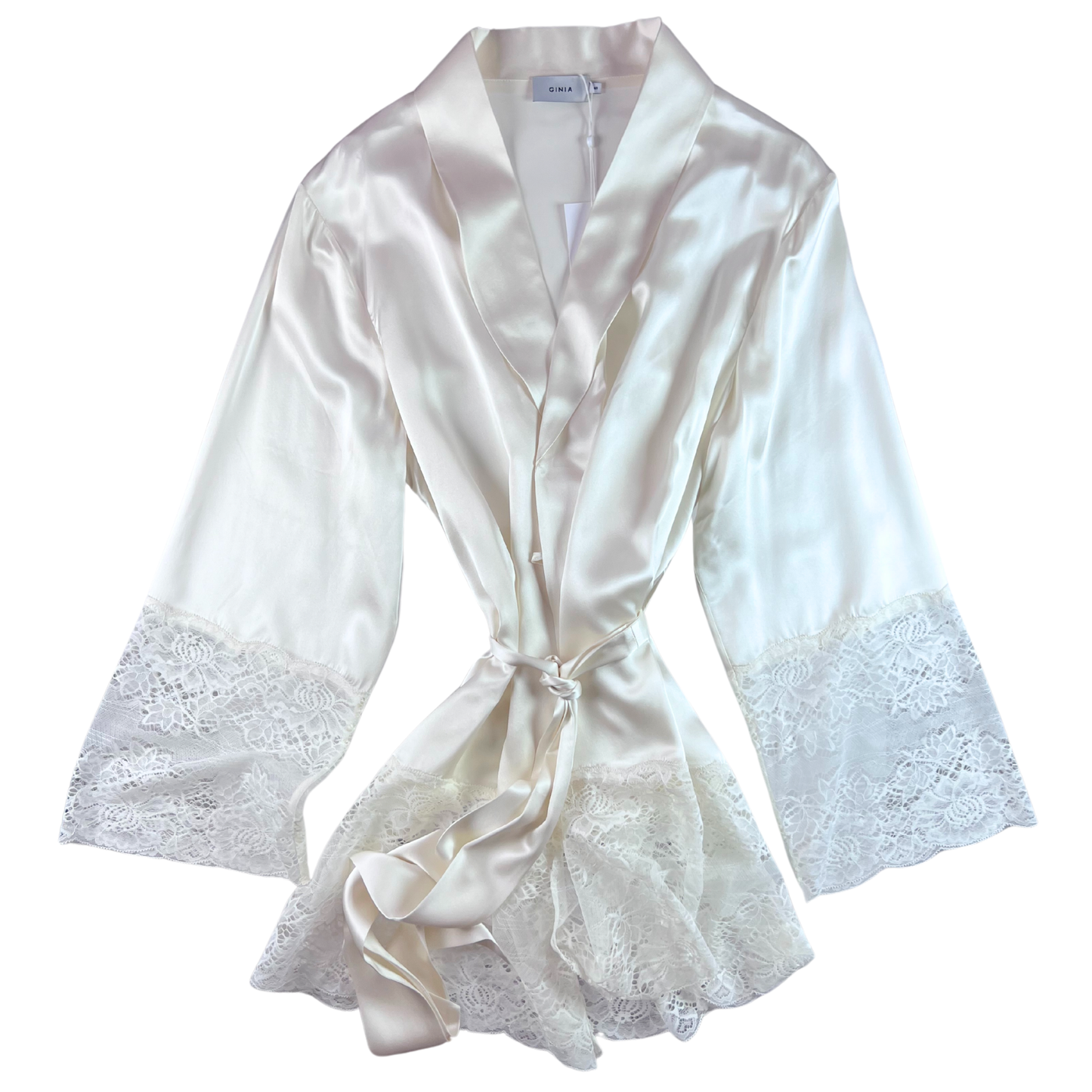 A beige silk lace robe with a round shawl collar and 3/4 length sleeves, secured with a silk belt and featuring French seams.