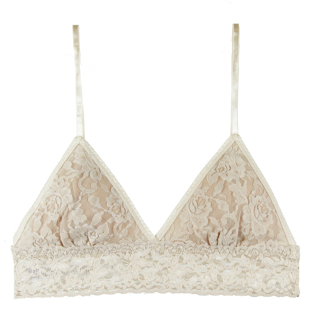 Beige lace bralette against a white background.