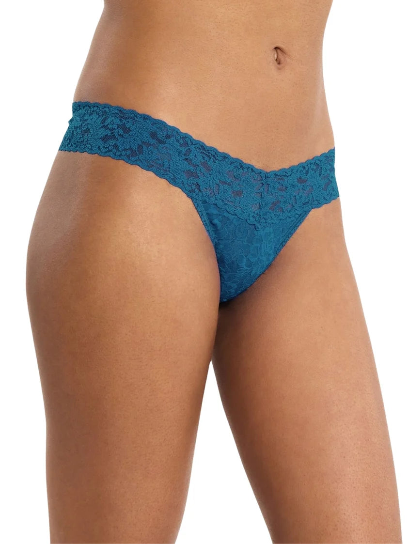 front of model wearing blue lace thong against a white background