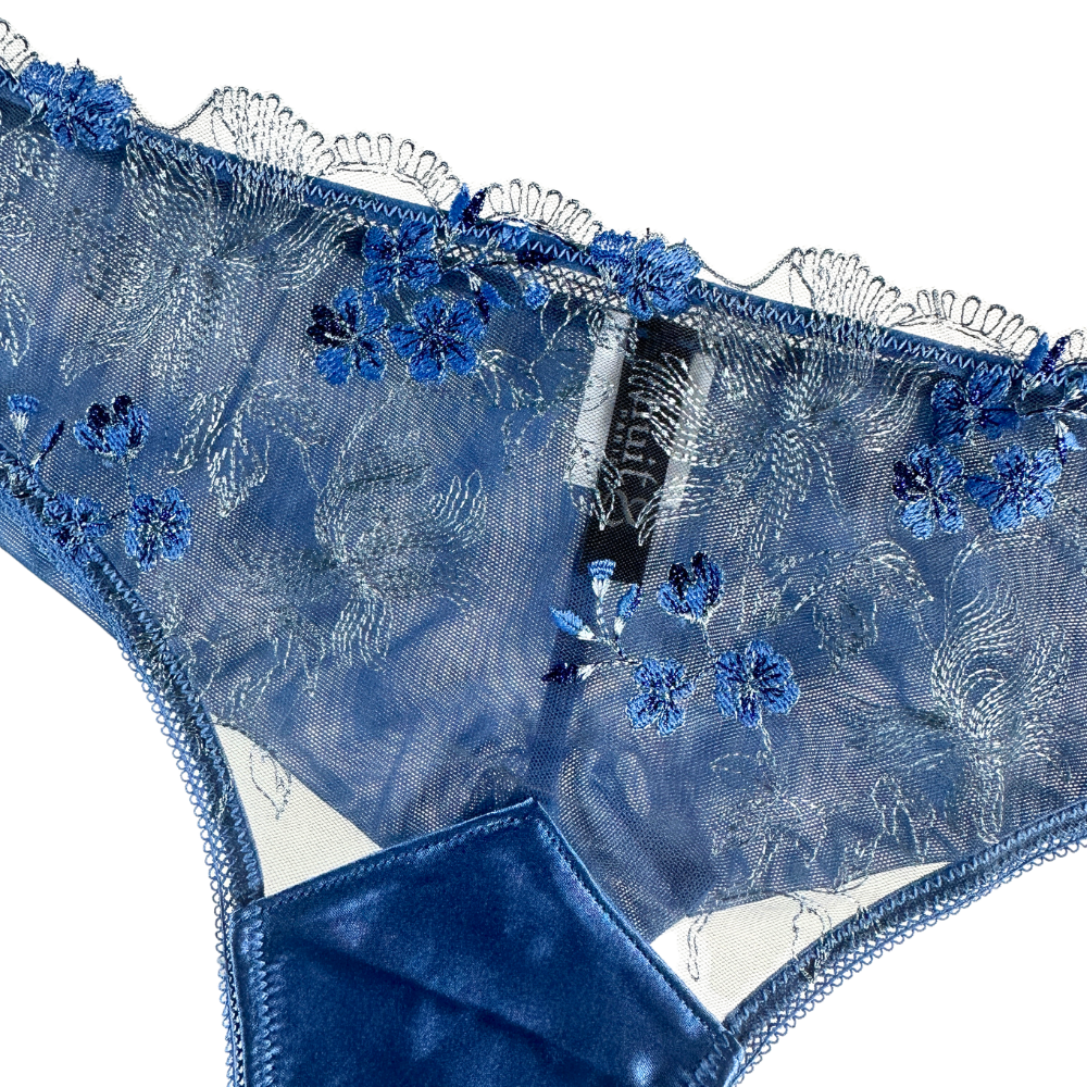 close up image of a blue thong against a white background