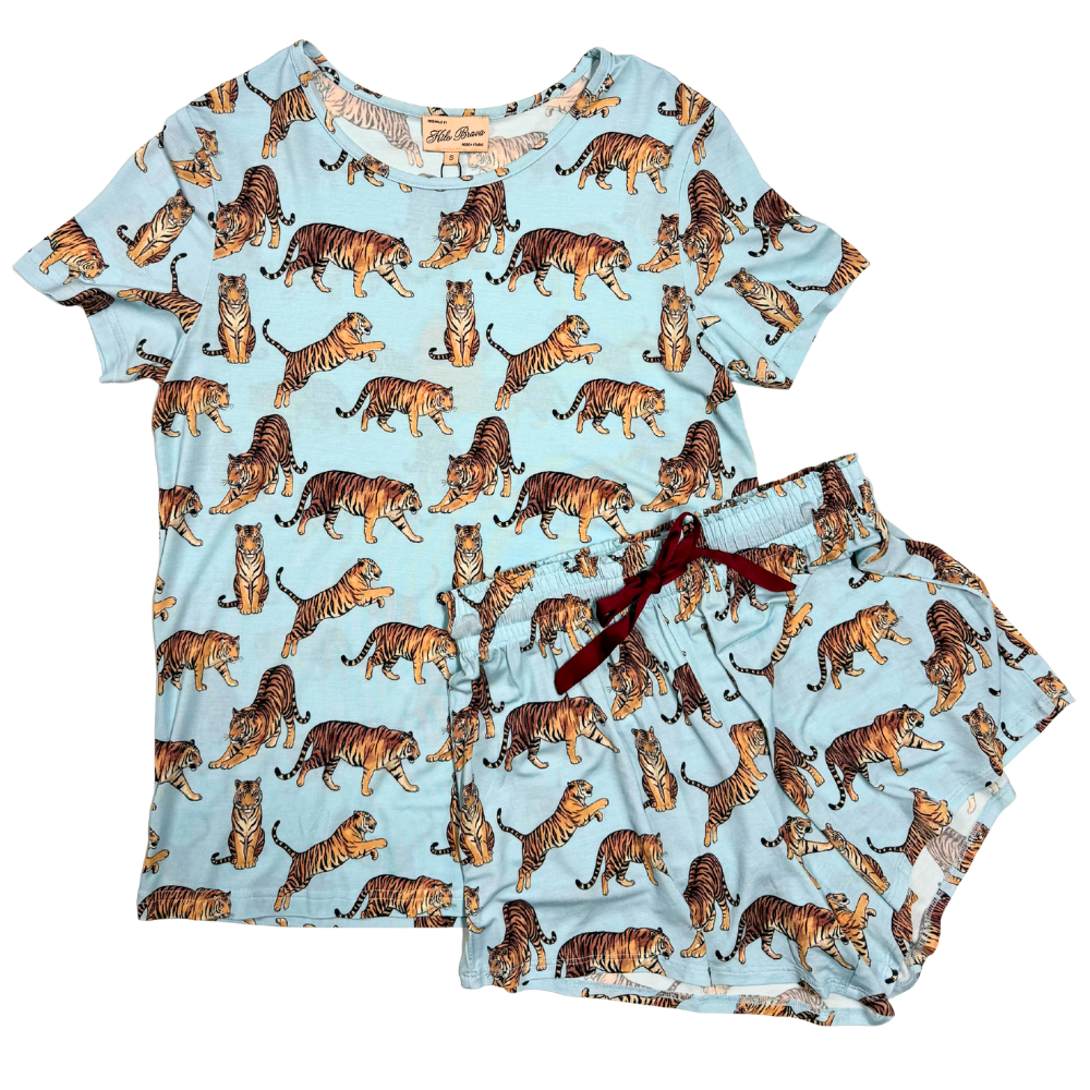 Blue matching shirt and short pjs  with tigers illustrated in an all over pattern against a white background.