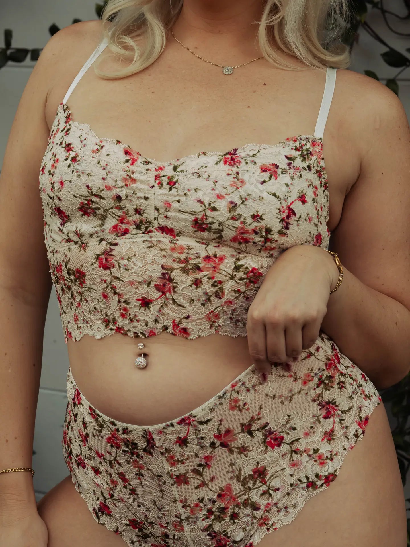 Person wearing a floral two-piece outfit with a neutral background