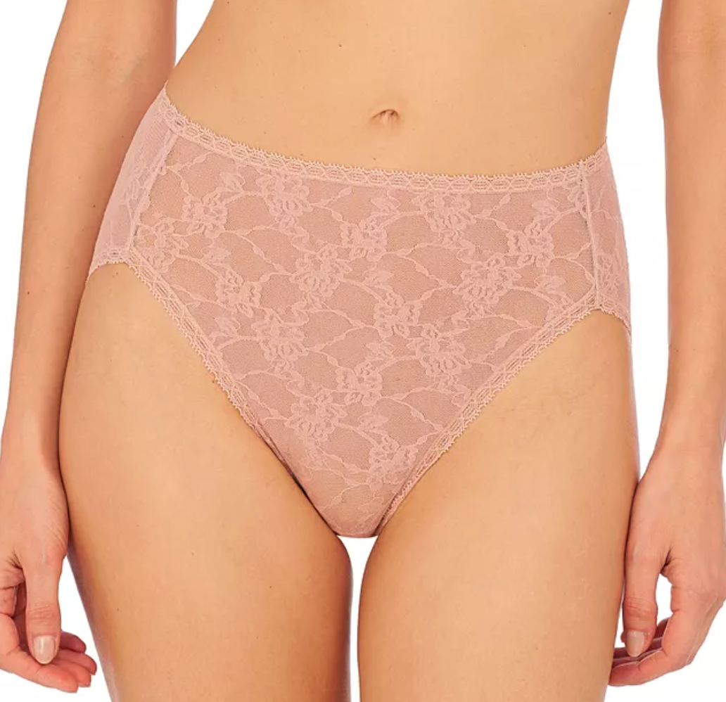 A close-up of a model wearing high-waisted lace underwear in a dusty rose pink color, showing the intricate floral lace pattern and waistband.