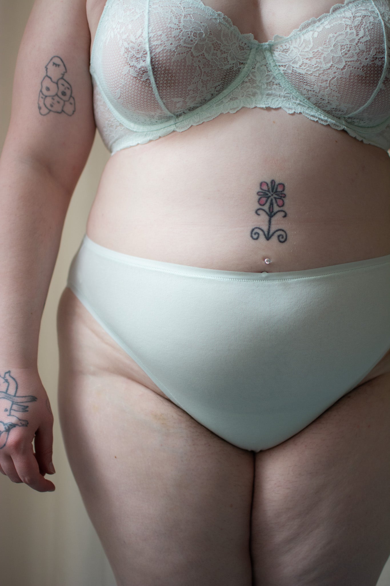 Natori bliss bare cotton high cut brief in iced mint, front view on a model, close-up.