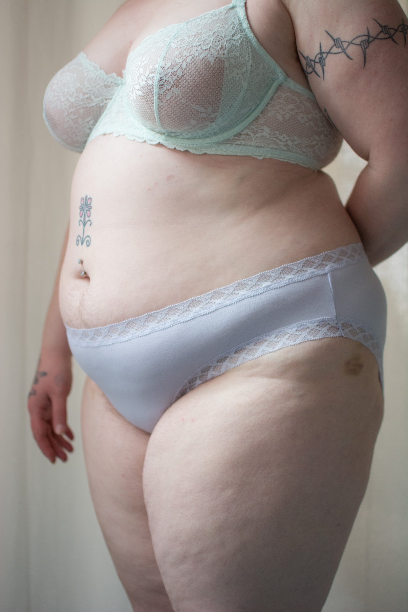 Natori Bliss girl brief in purple pearl, side view on a model, close-up.