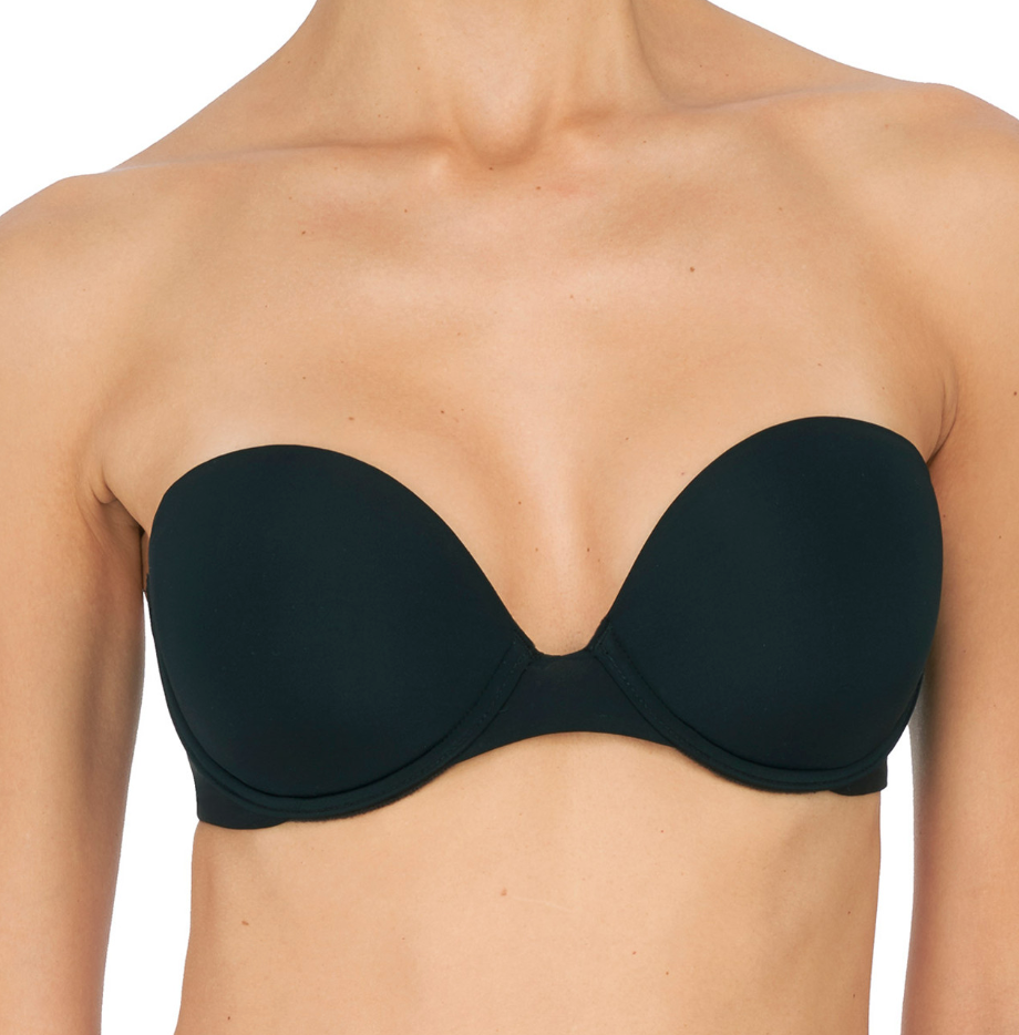 Person wearing black bra against a neutral background