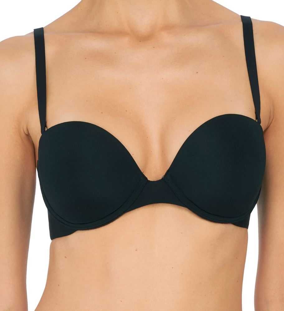 Person wearing black bra against a neutral background