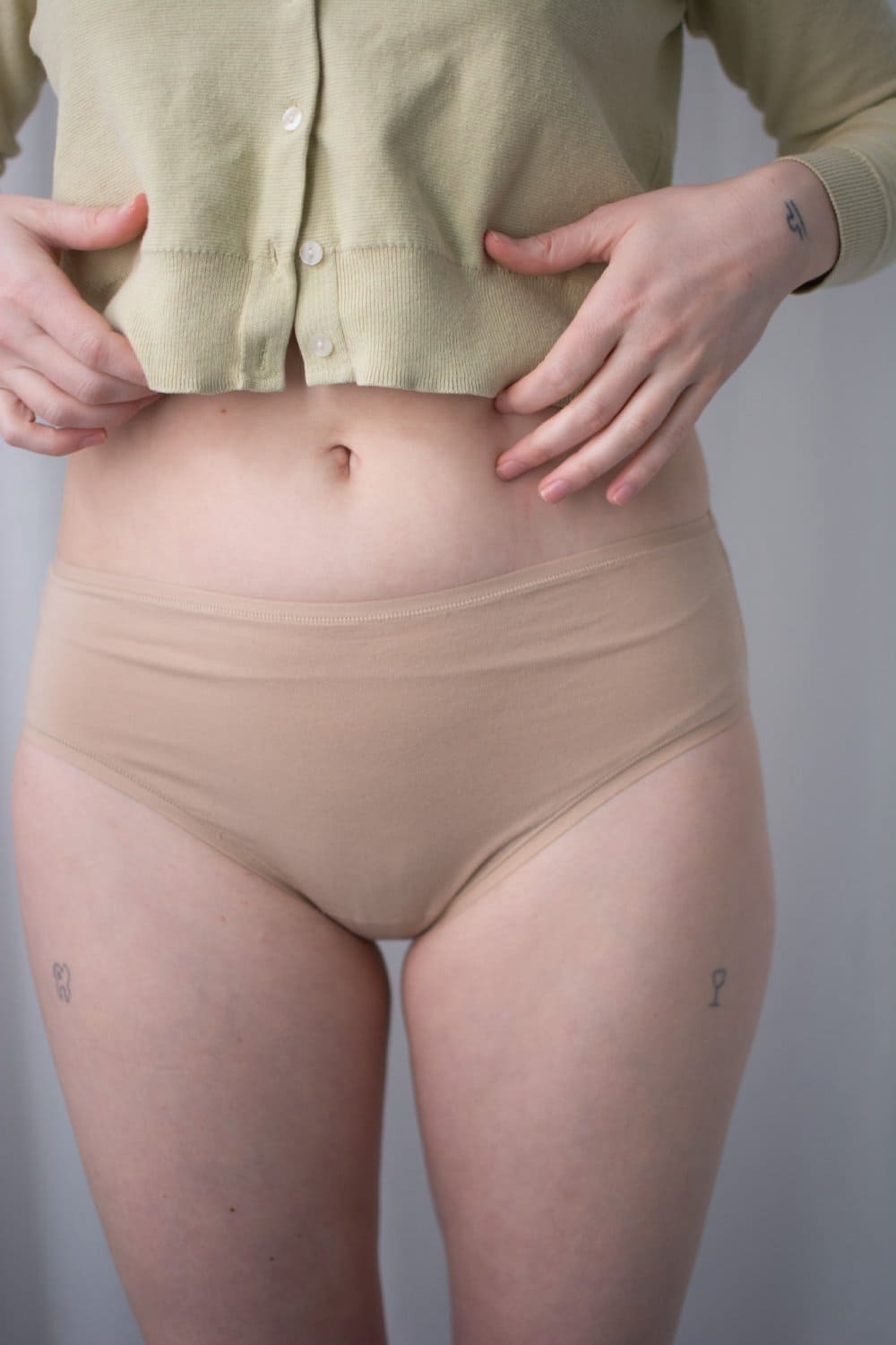Natori bliss bare cotton hipster in cafe, front view on a model, close-up.