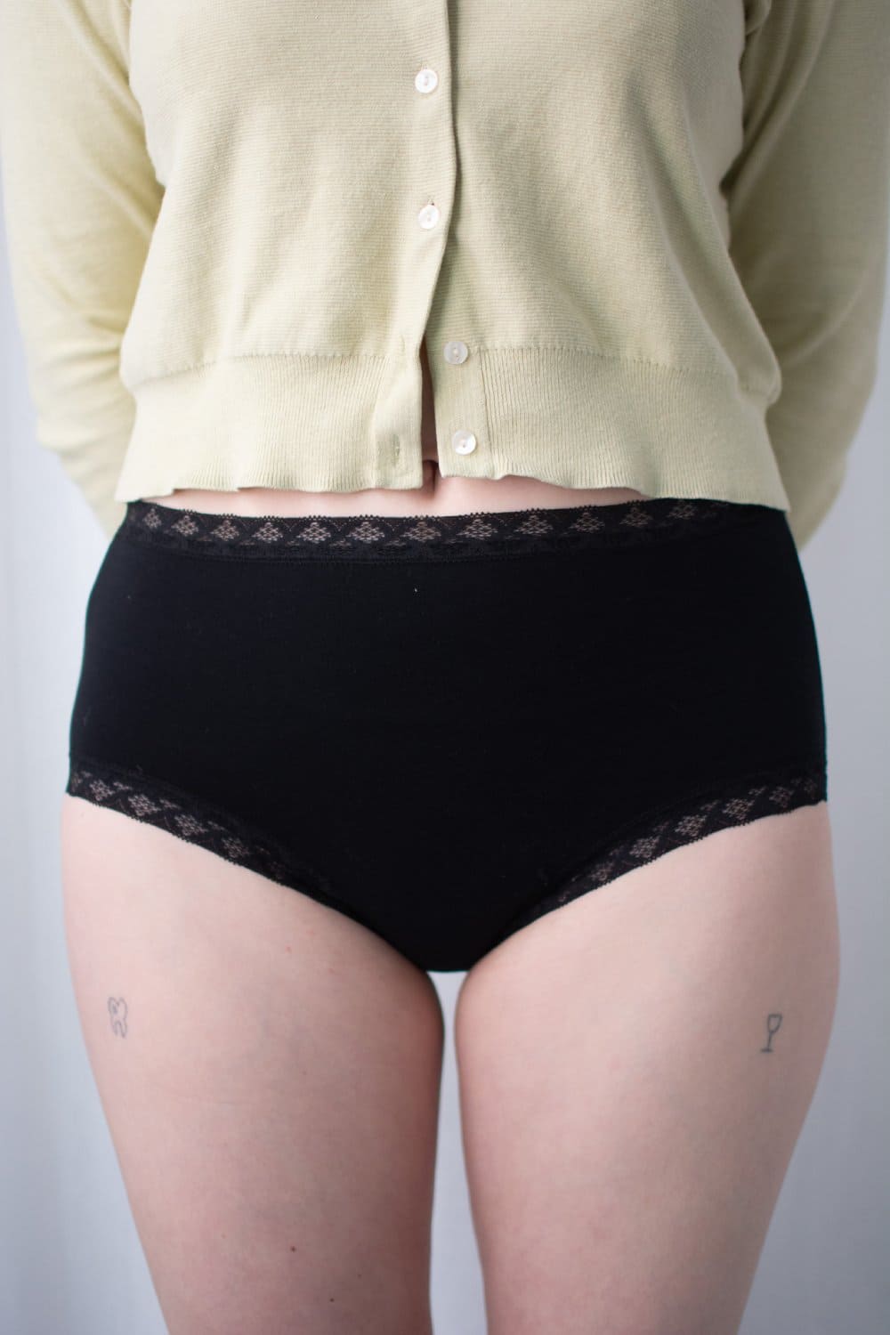 Natori Bliss full brief in black, front view on a model, close-up.