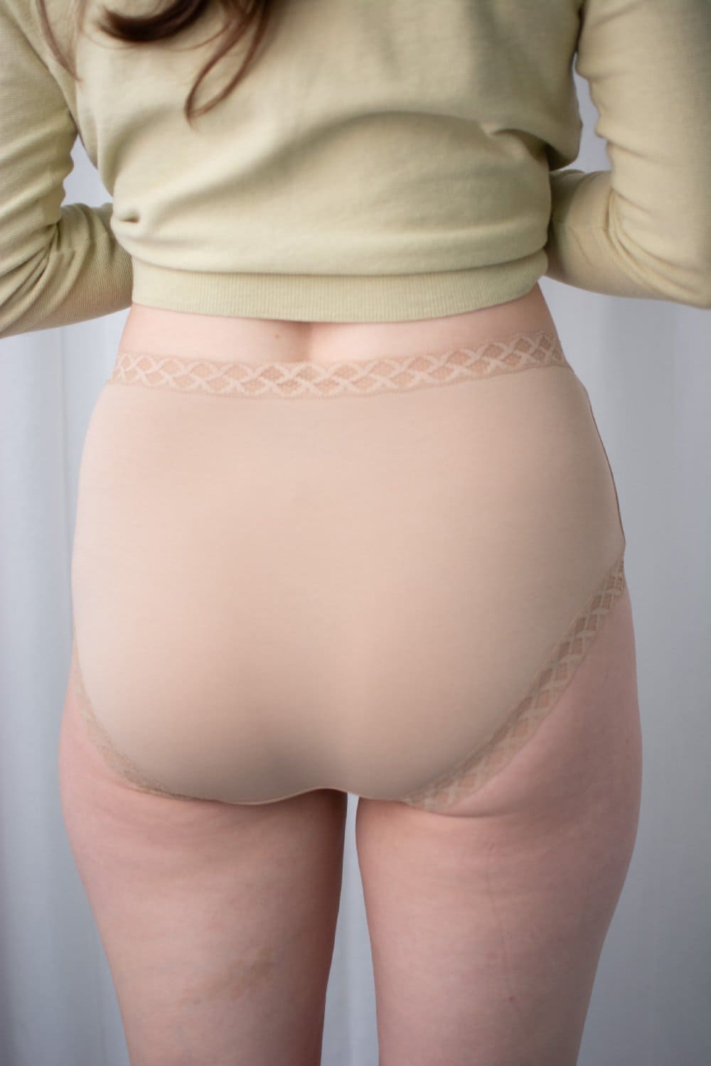 Natori Bliss full brief in cafe, back view on a model, close-up.