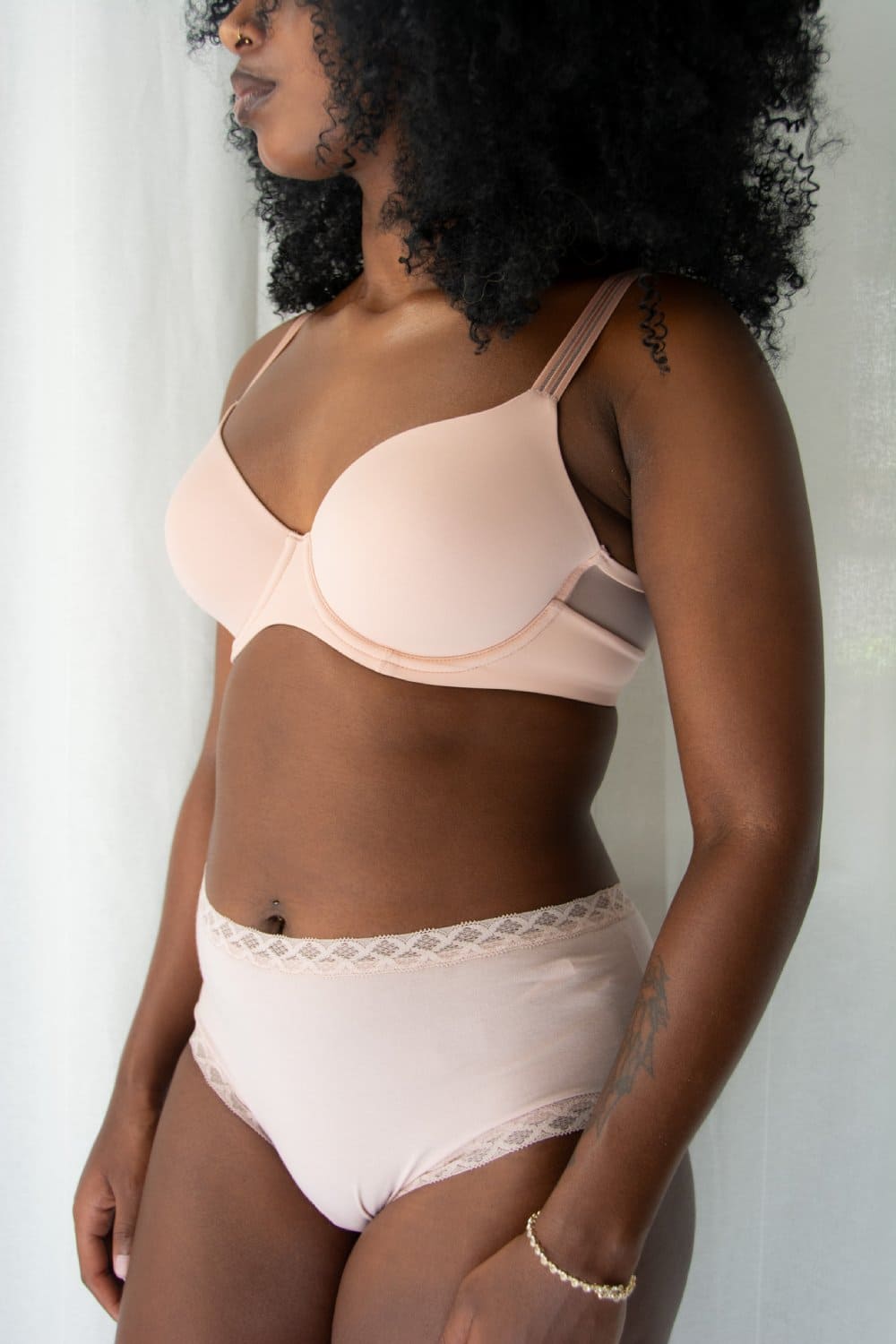 Natori Bliss full brief in rose beige, front-side view on a model, close-up.