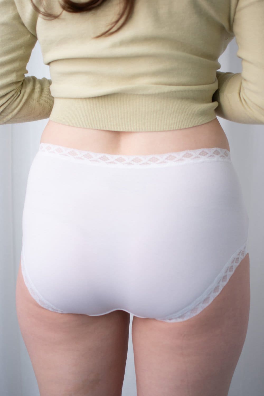 Natori Bliss full brief in white, back view on a model, close-up.