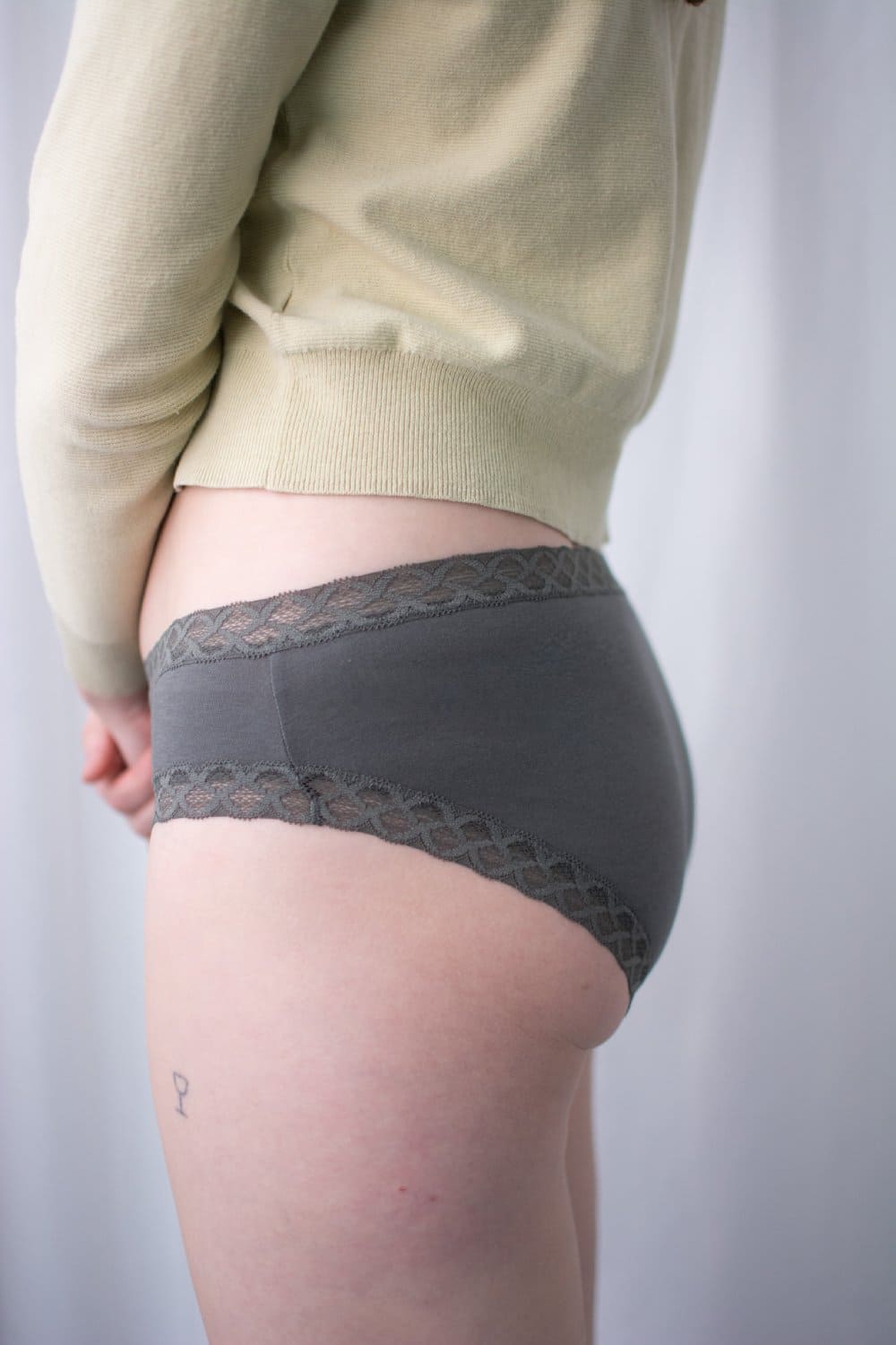 Natori Bliss girl brief in flint, side view on a model, close-up.