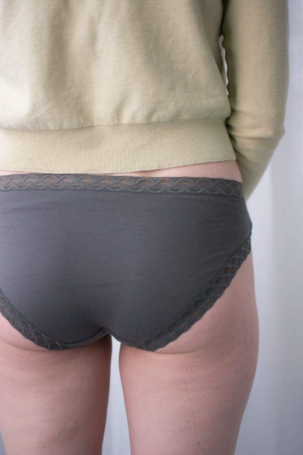 Natori Bliss girl brief in flint, back view on a model, close-up.