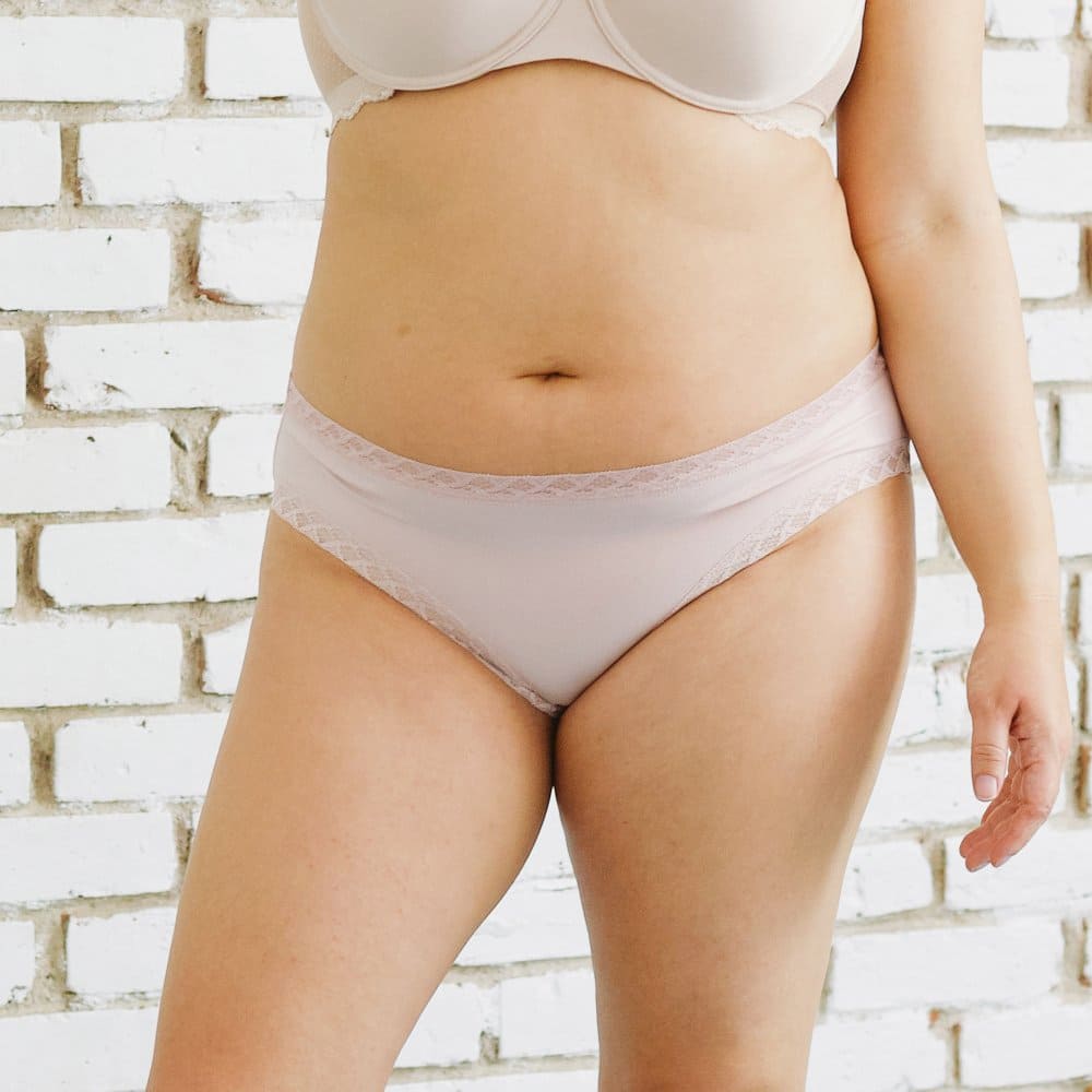 Natori Bliss girl brief in rose beige, front view on a model, close-up.