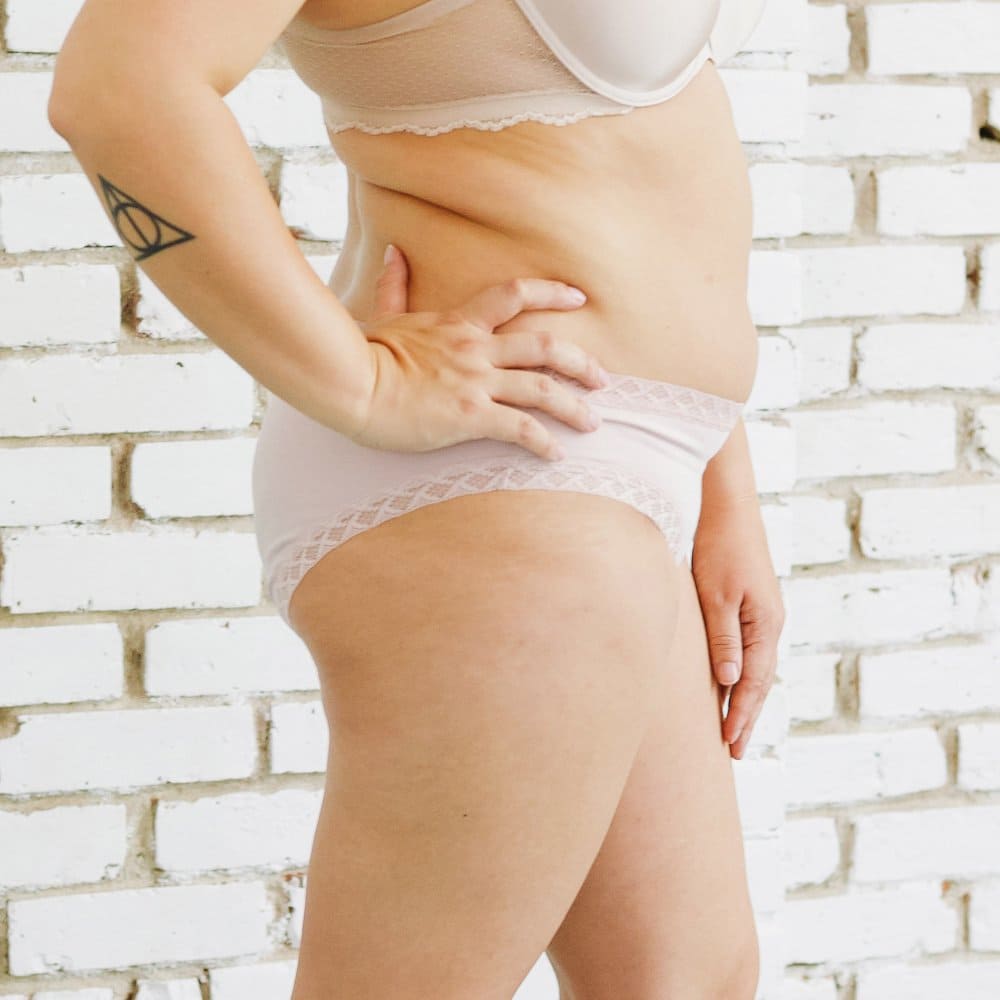 Natori Bliss girl brief in rose beige, side view on a model, close-up.