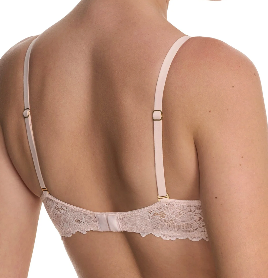 Back view of a woman wearing a pale blush pink lace bra with thin adjustable straps and gold-tone metal adjusters, shown against a plain white background.