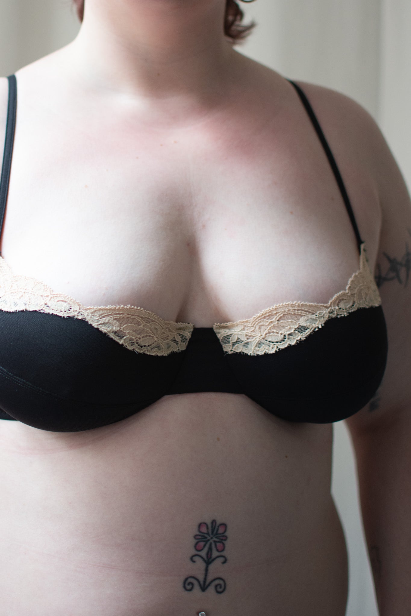 Person wearing black bra with lace trim.