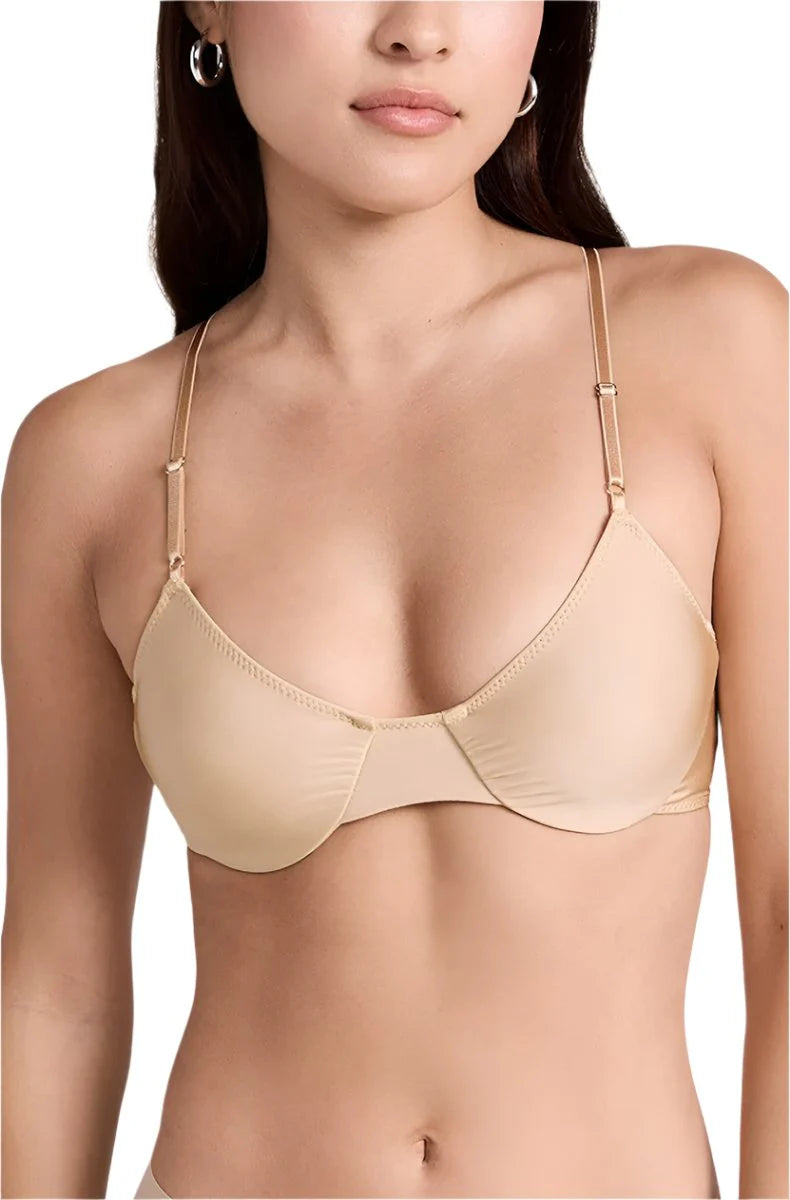 Beige bra worn by a model on a white background