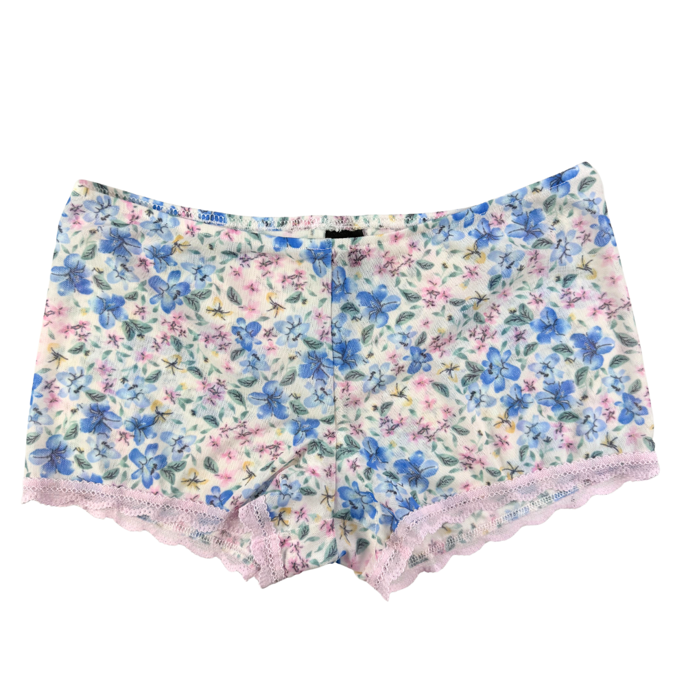 Floral patterned shorts with lace trim on a white background