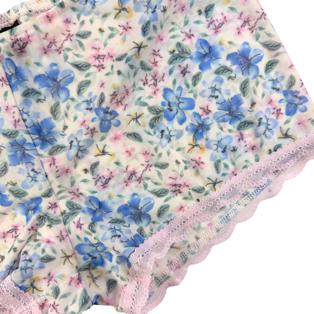 Floral-patterned fabric with pink lace trim on a white background